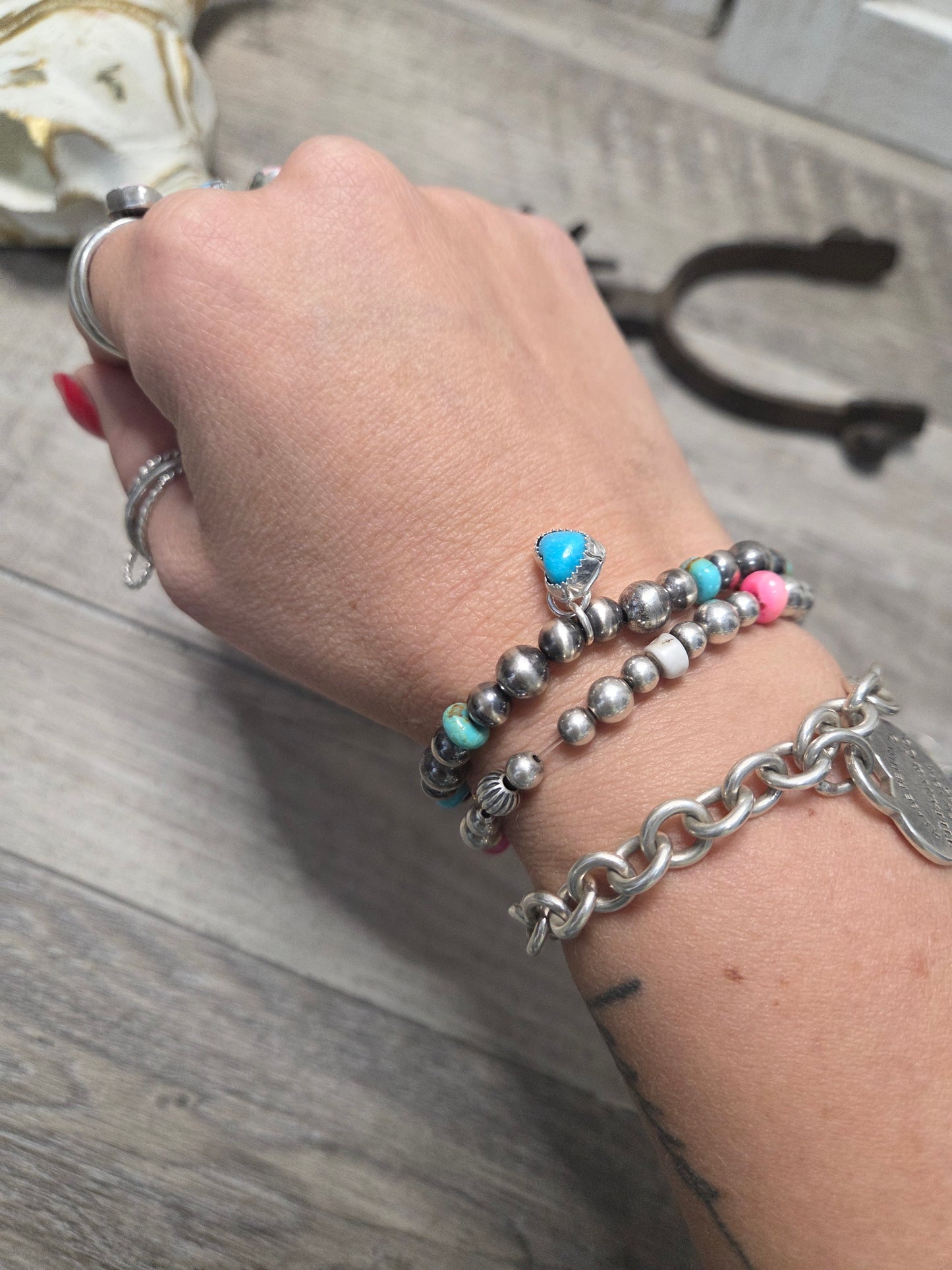 Kingsmen Turquoise Heart charm with Kingsmen Turquoise beads and Turquoise & Sterling Silver Navajo Style Pearls.  Stretch Bracelet