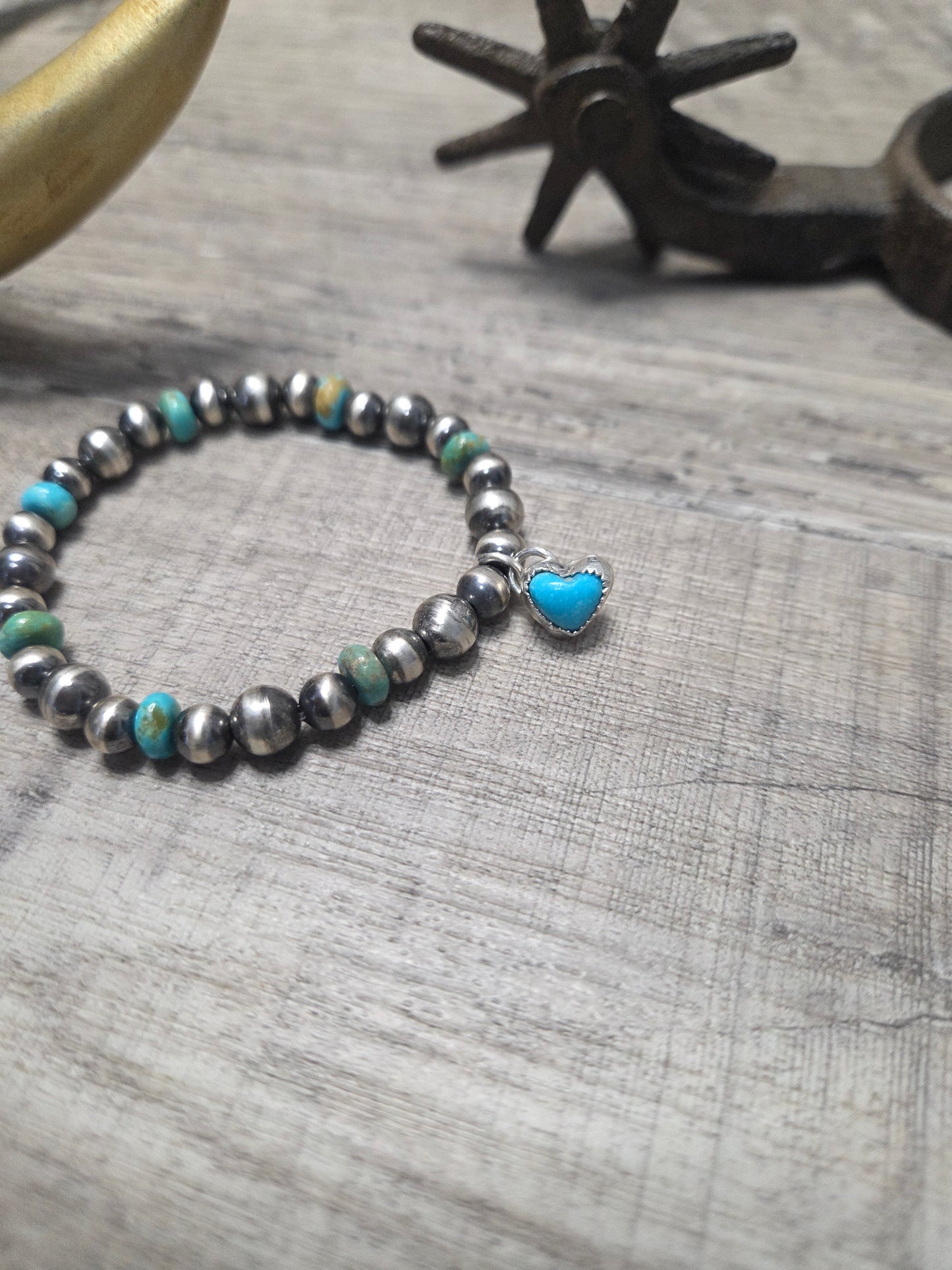 Kingsmen Turquoise Heart charm with Kingsmen Turquoise beads and Turquoise & Sterling Silver Navajo Style Pearls.  Stretch Bracelet