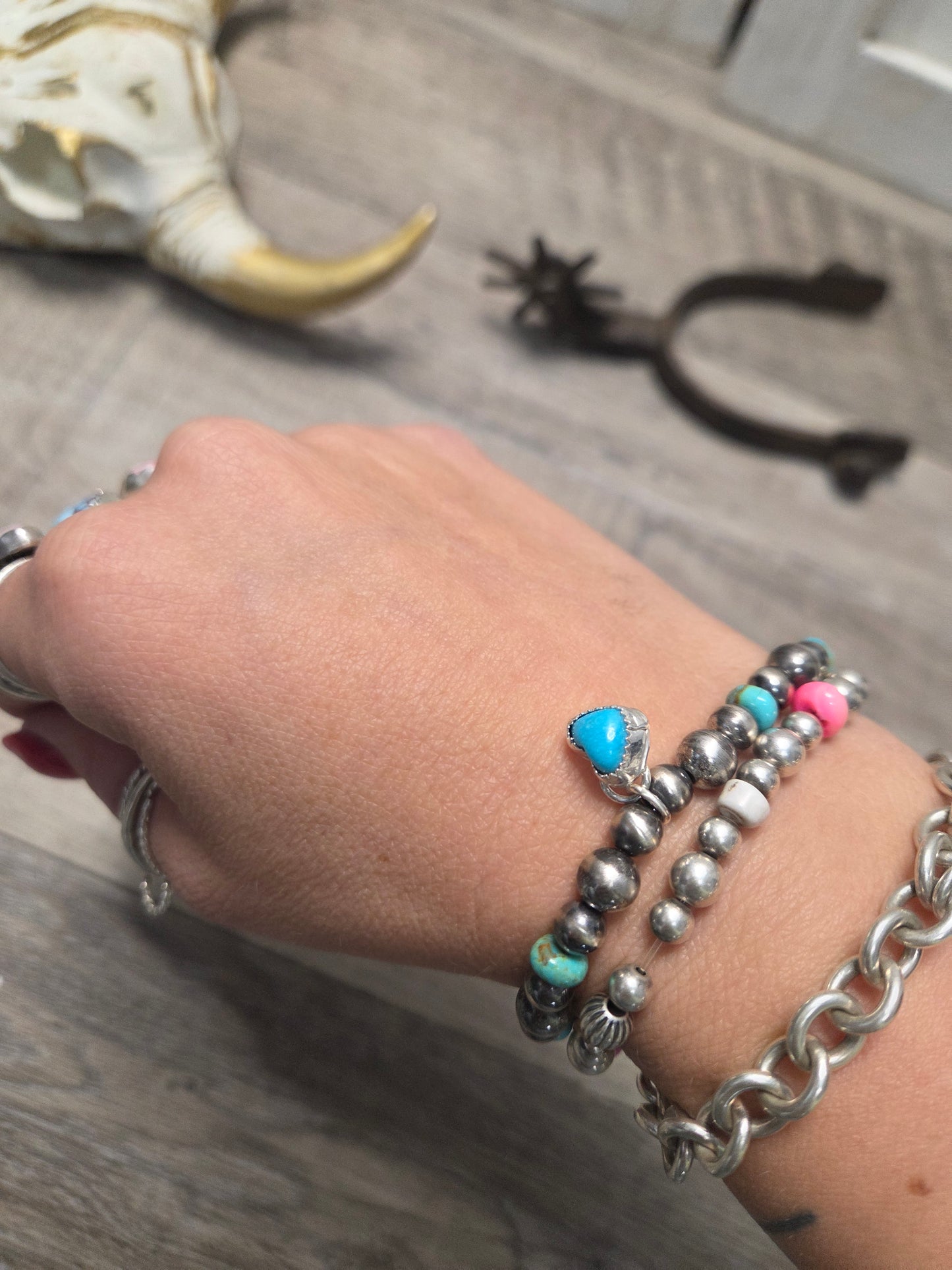 Kingsmen Turquoise Heart charm with Kingsmen Turquoise beads and Turquoise & Sterling Silver Navajo Style Pearls.  Stretch Bracelet